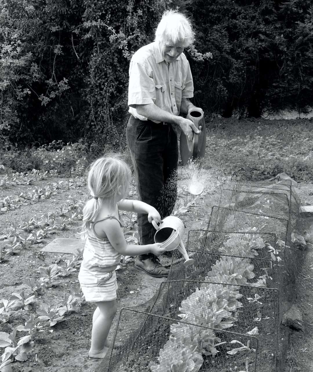Mark with one of his granddaughters, Willow, doing some watering and passing on gardening skills. Picture submitted
