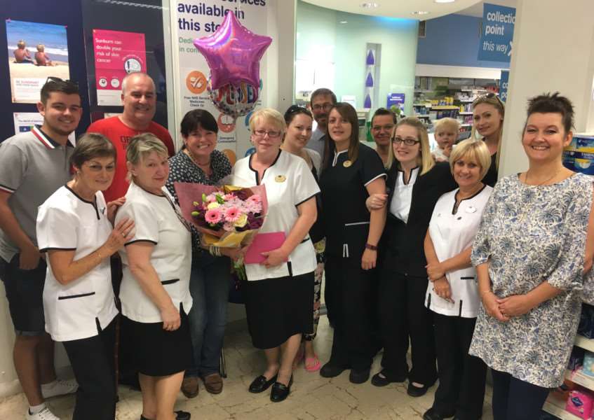 Diane Ruddock surrounded by friends and colleagues on her final day of work at Boots in Diss. Picture: Andrew Martin.