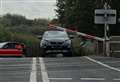 Investigation after car trapped under railway barrier