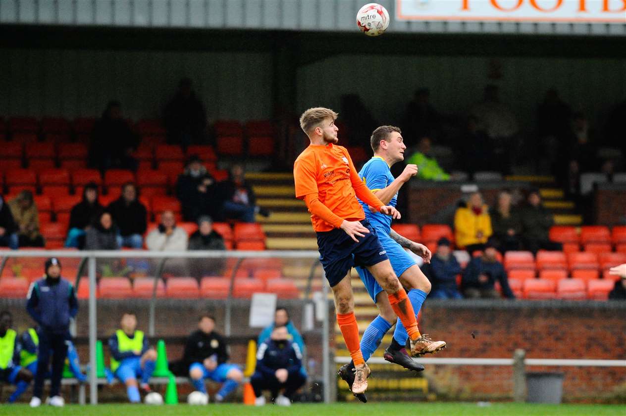 Diss defender Harry Creamer challenges March's Craig Gillies in the air. Picture: Mark Bullimore Photography.