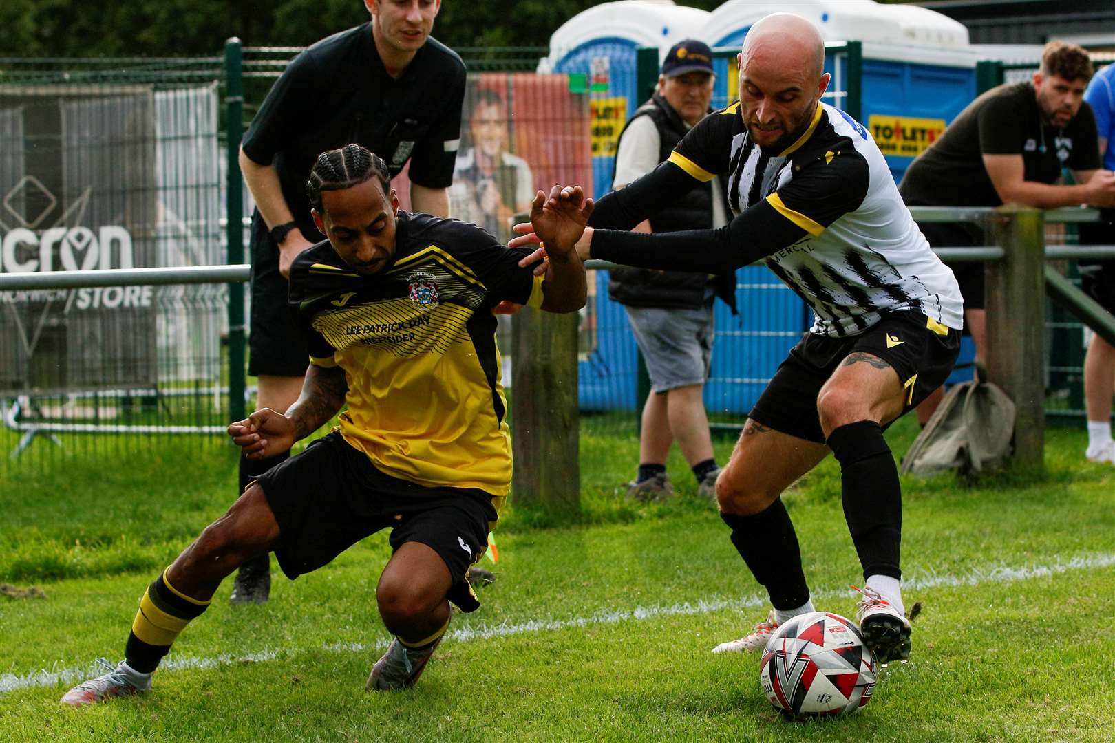 Harleston, Norfolk, 07/10/2023Football action from Harleston Town vs Hadleigh United in the Thurlow Nunn LeagueAsa McGeachey (HT) and Lloyd Clarke (HU)Picture: Mark Bullimore Photography 2023