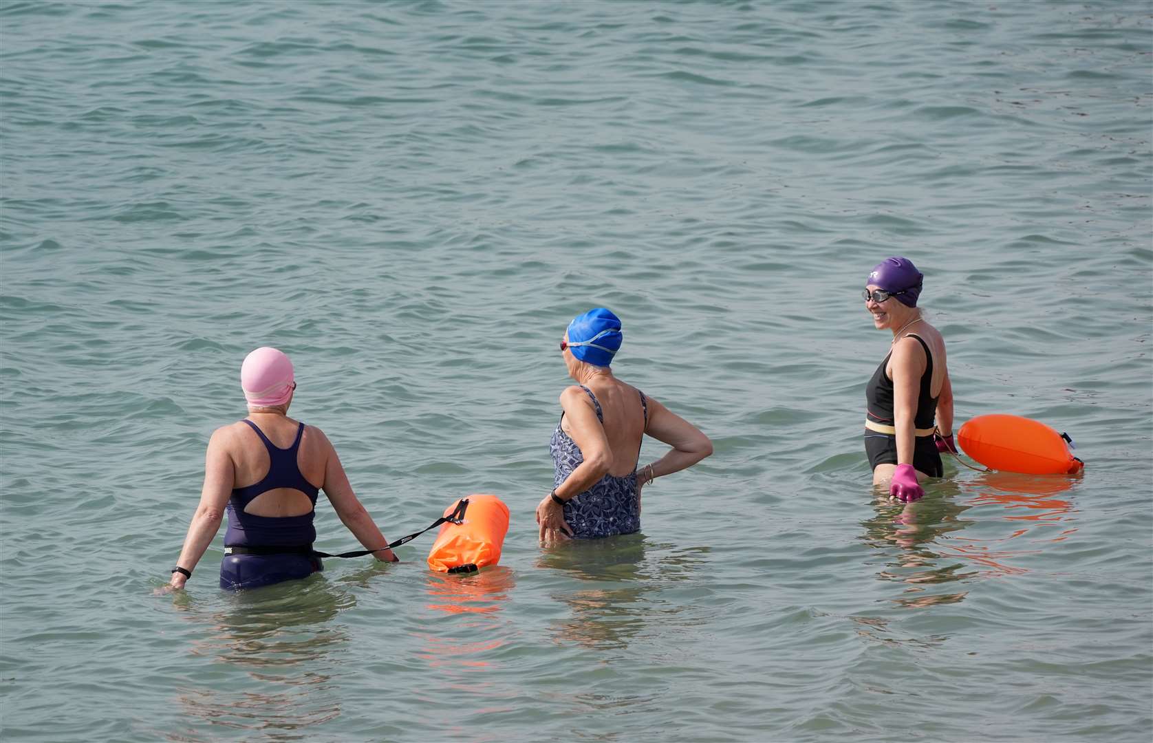 Swimmers head into the sea during the morning sunshine in Dover, Kent (Gareth Fuller/PA)