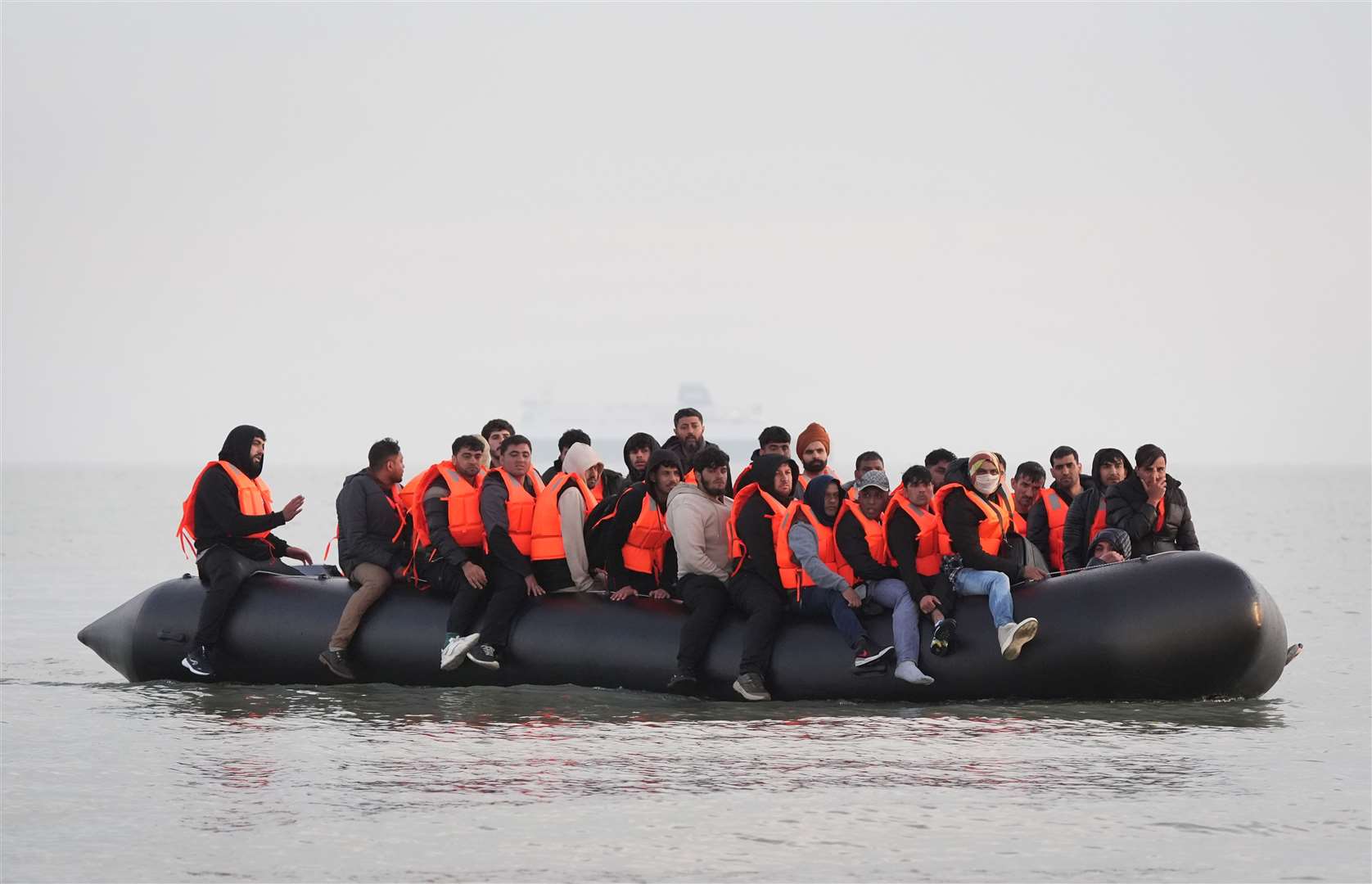 A group of people thought to be migrants onboard a small boat leaving the beach at Gravelines, France, attempting to reach the UK (Gareth Fuller/PA)