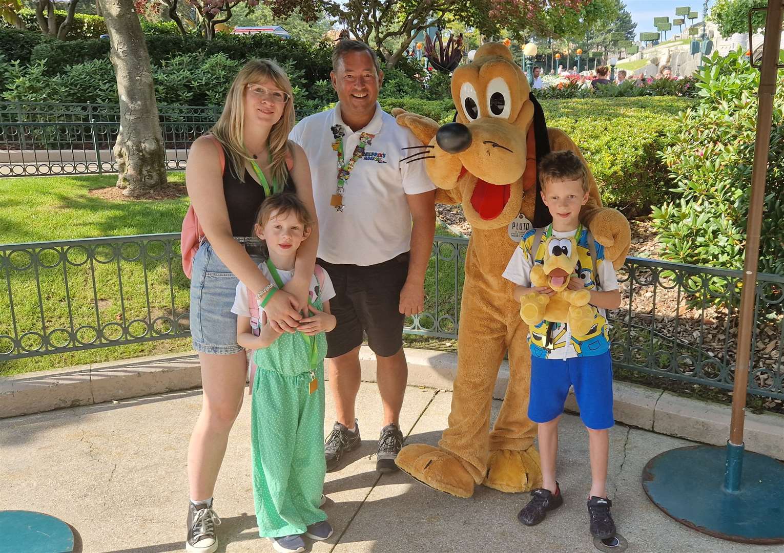 Dog treat: Michaela, Johnny and Amara Poll rub shoulders with Pluto at one of the meet-and-greet stations.