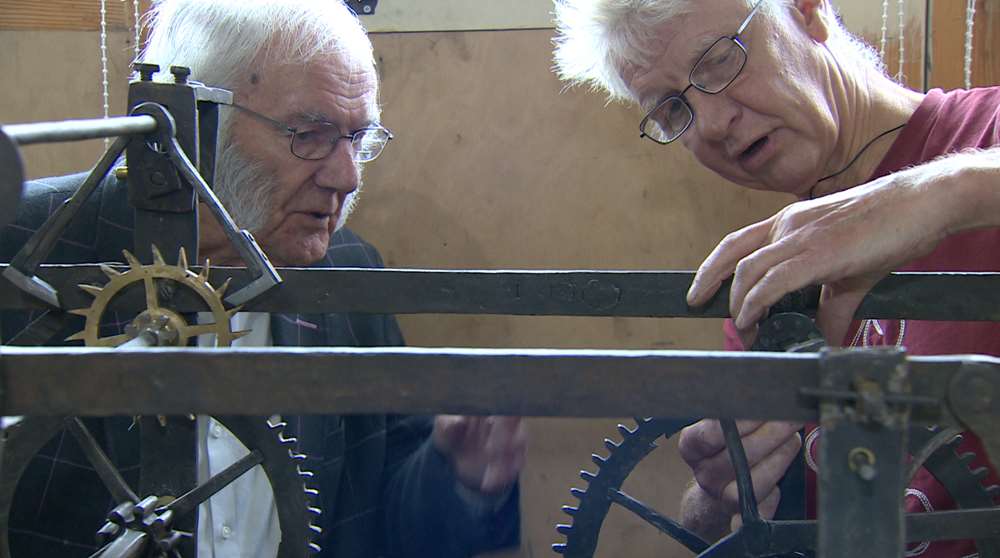 Humphrey Hamlin, left, who previously worked on restoring the clock, joins Mr Boyd in re-installing the mechanism inside the church tower (Grace productions/PA)