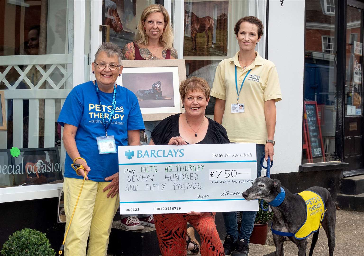 Lisa North, presents the cheque to charity Pets as Therapy.