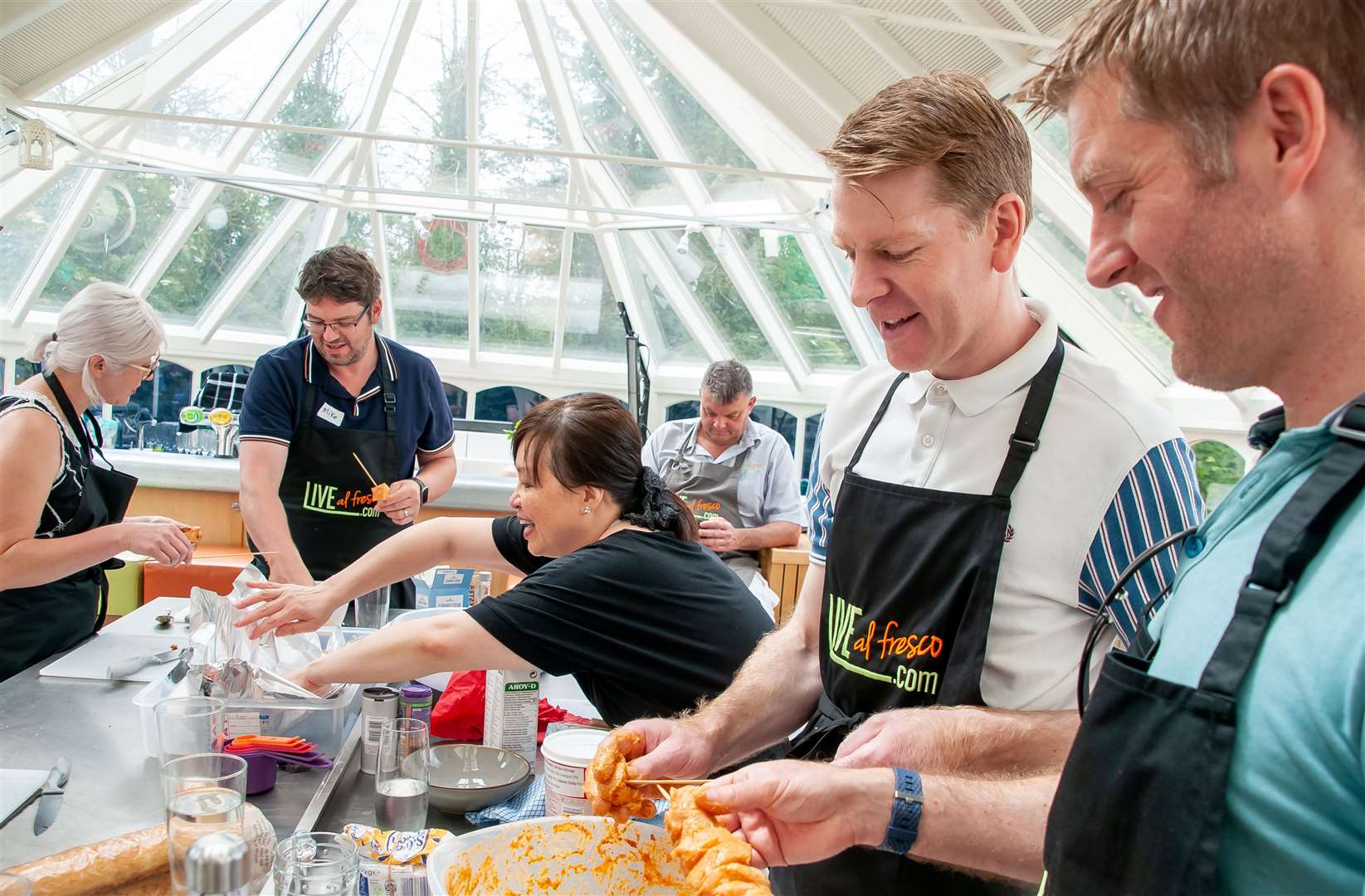 SuffolkNews' Russell Claydon (right) loads up the Thai chicken skewers on the Live Al Fresco BBQ cooking course Picture: Wendy Aiken Photography