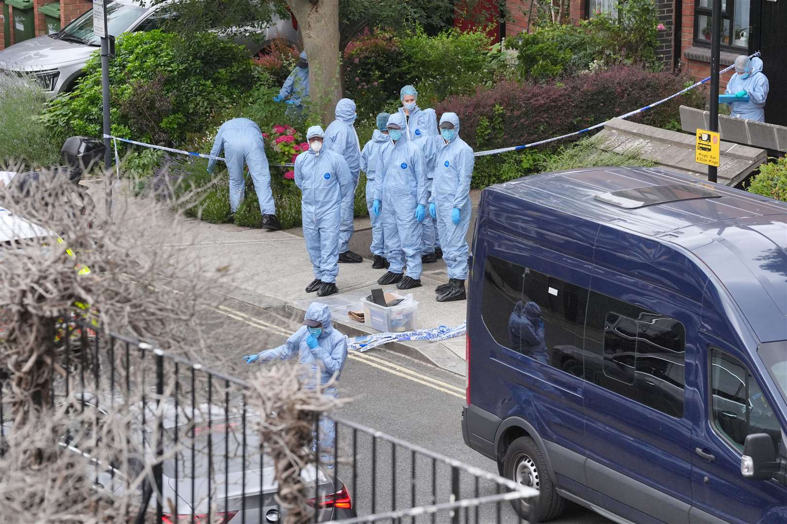 Forensic officers at an address in Shepherd’s Bush, west London, after human remains were found (Jonathan Brady/PA)