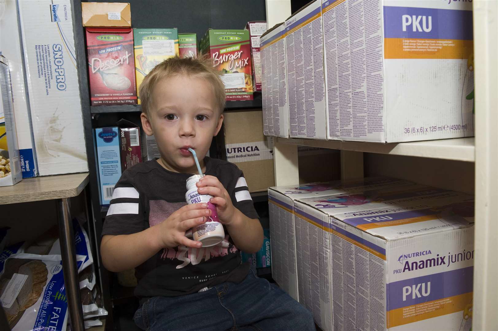 Timmie-Joe shows off the cupboard full of special prescription food he has to eat.