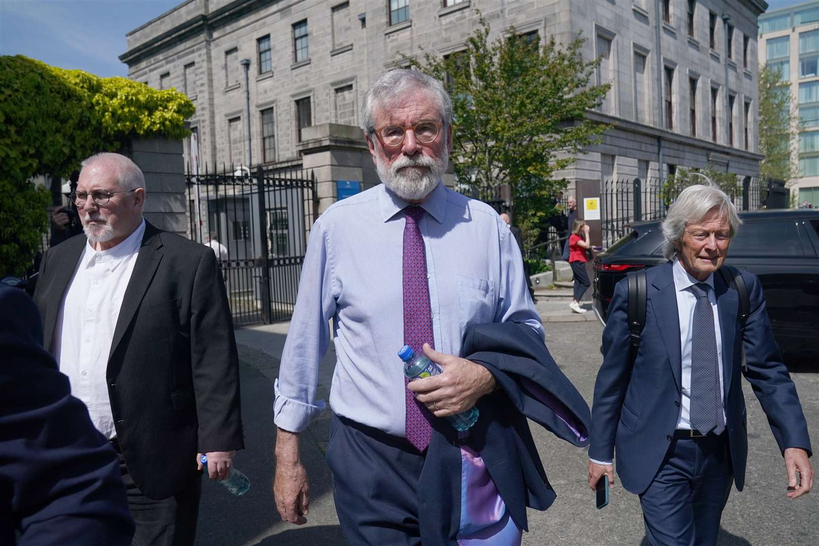 Former Sinn Fein president Gerry Adams (centre) and solicitor Paul Tweed (right) outside the High Court in Dublin (PA)