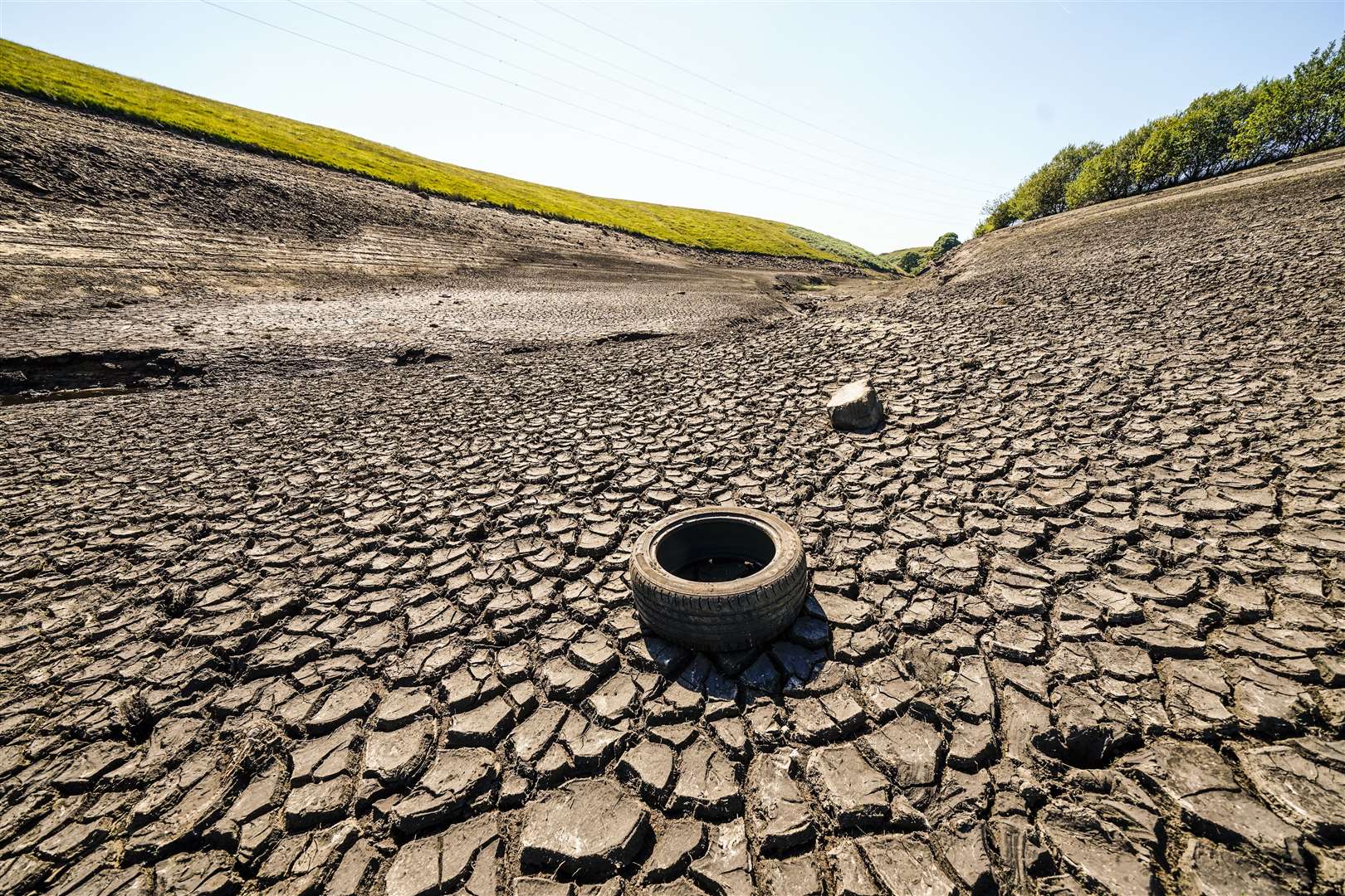 Dry cracked earth at Baitings Reservoir in Ripponden, West Yorkshire in 2022 (Danny Lawson/PA)