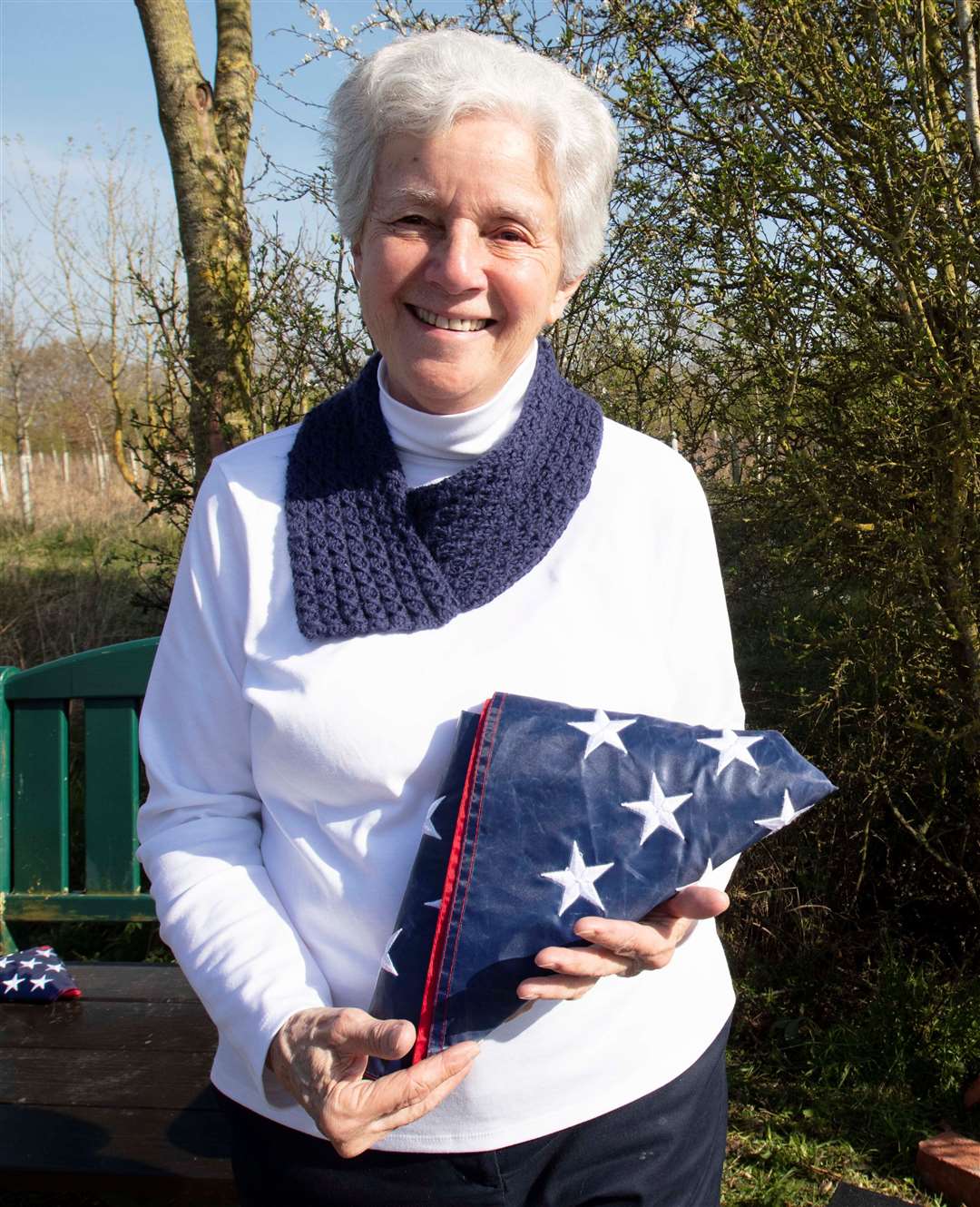 Mrs Pat Muller holds the ceremonially folded ‘Stars and Stripes’. Picture: Royal British Legion