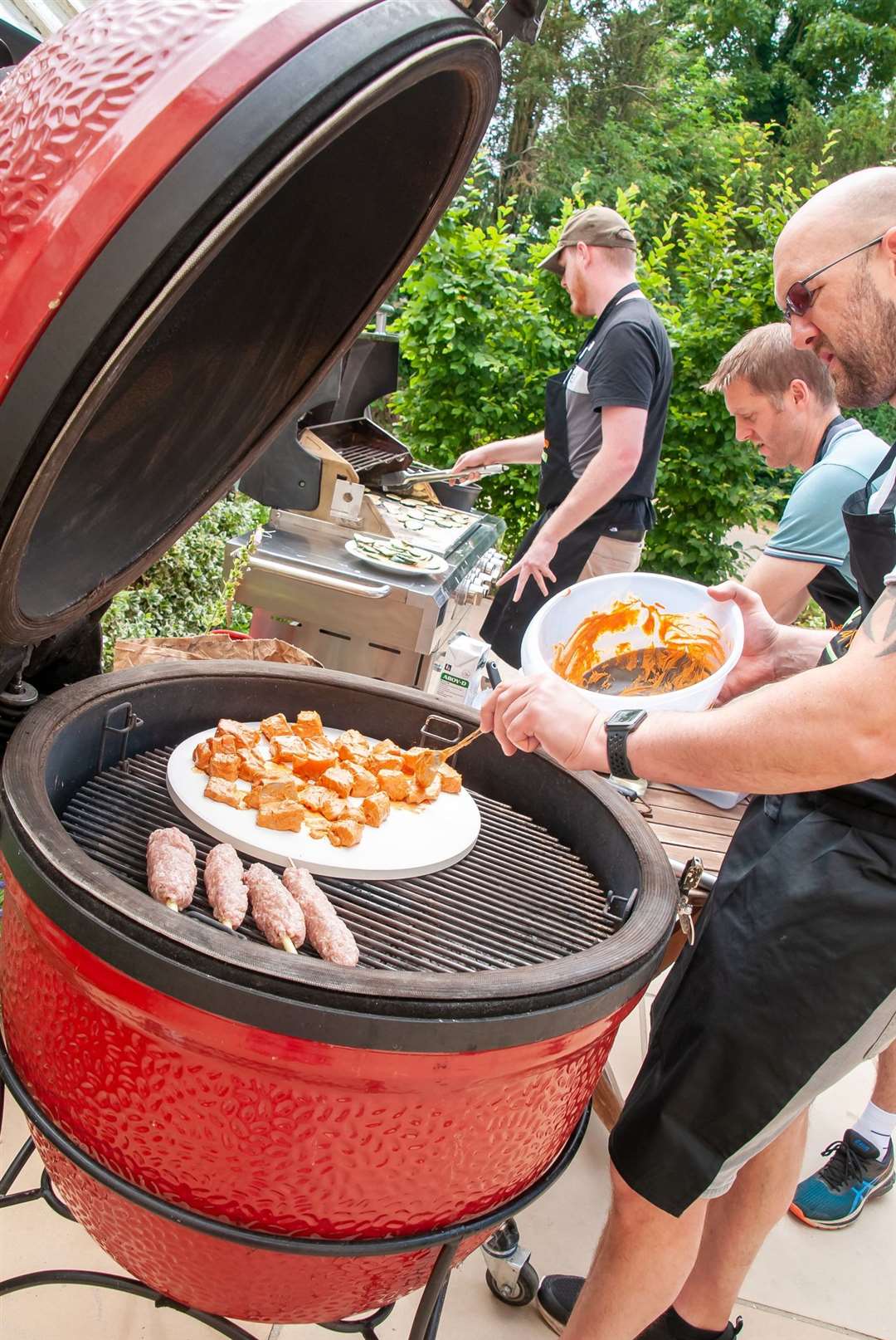 SuffolkNews' Russell Claydon (second from right) gets involved in the cooking process at the Thai Vietnamese BBQ cooking course run by Live Al Fresco at The Oaksmere in Eye Picture: Wendy Aiken Photography
