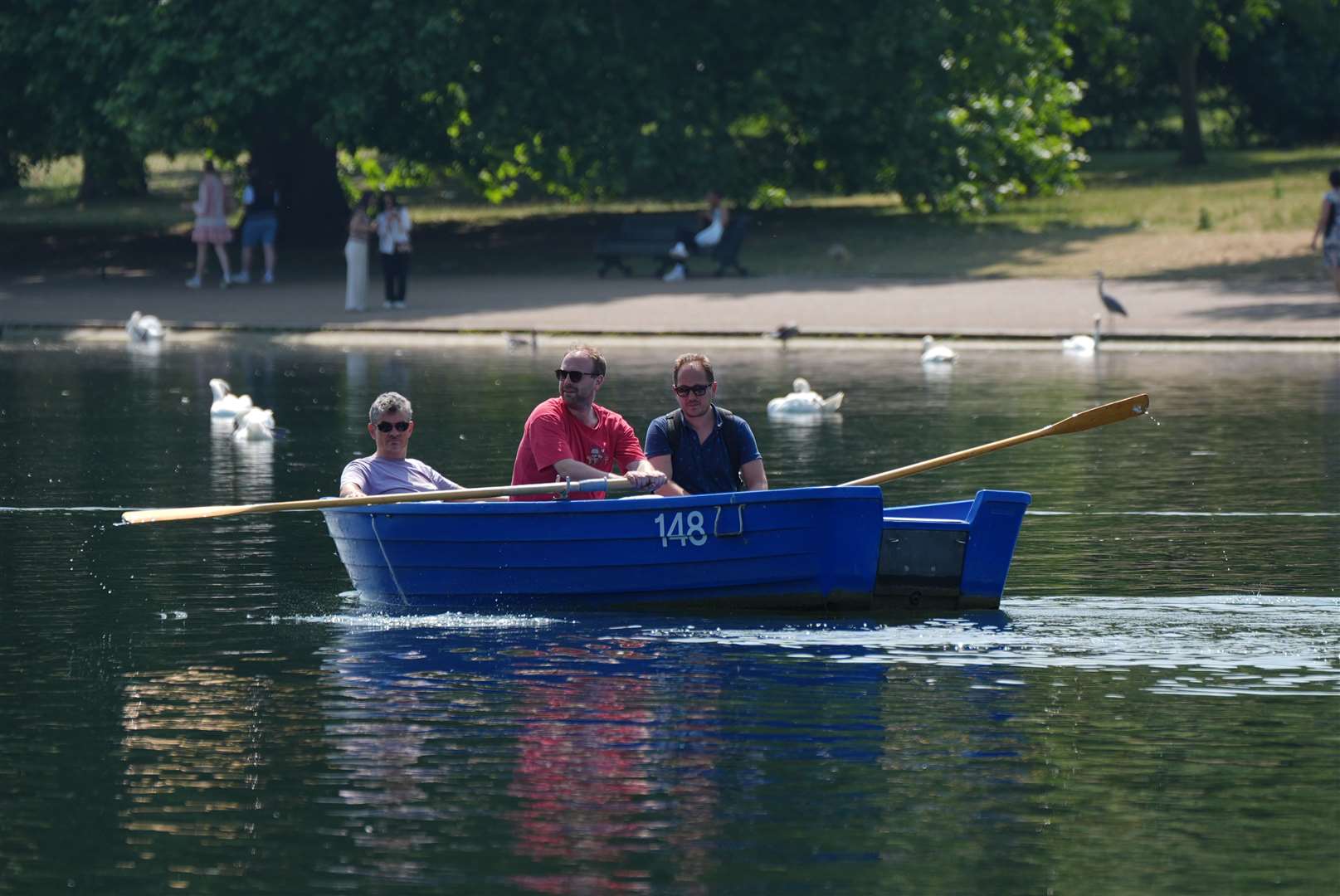 People in a row boat on the Serpentine in Hyde Park, London (Yui Mok/PA)