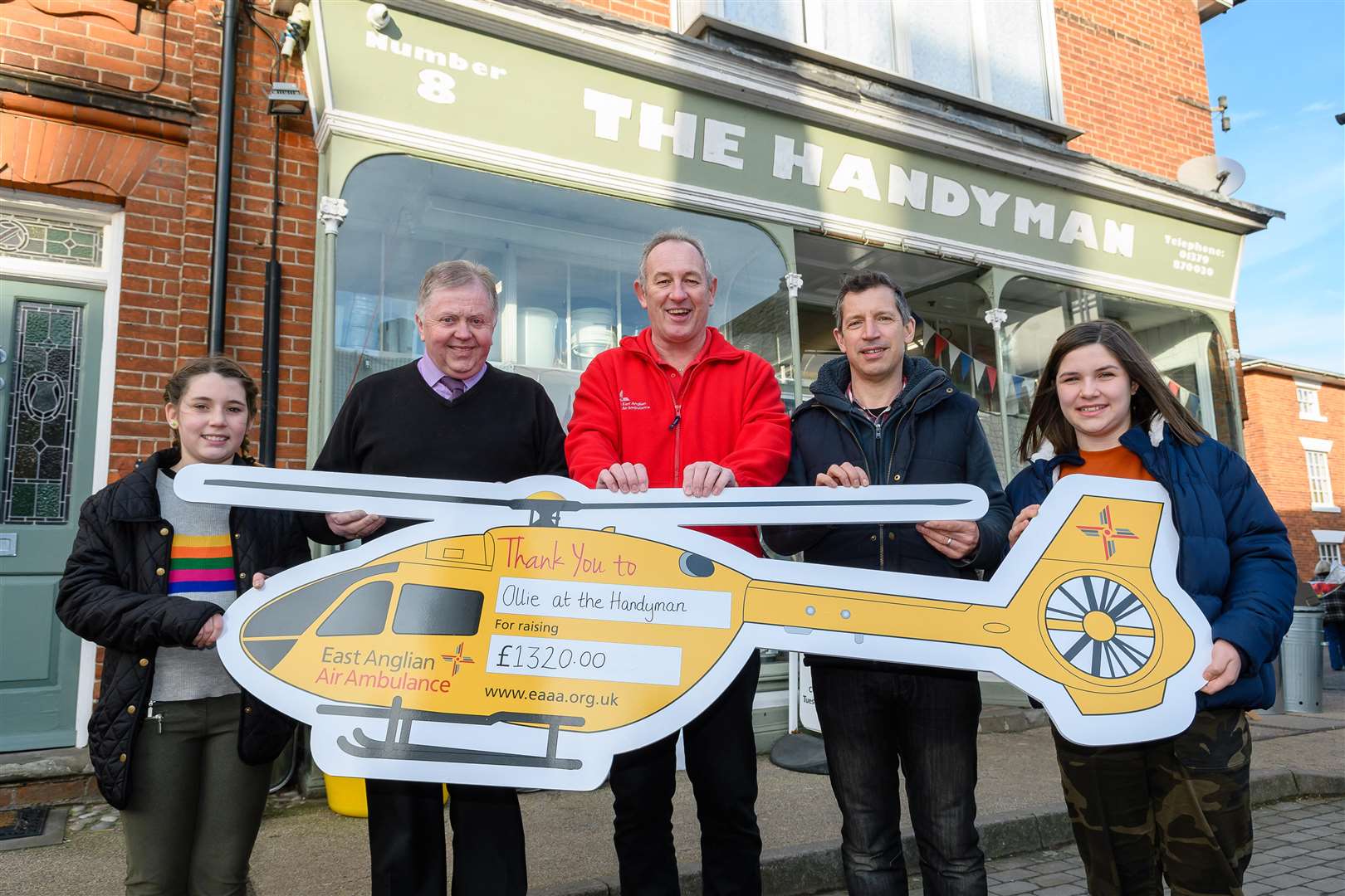 Pictured from left Ruby Salter, Ollie Green, Terry Wigg, (East Anglian Air Ambulance), Bruce Salter and Rose Salter outside The Handyman in Eye. Picture by Mark Bullimore Photography
