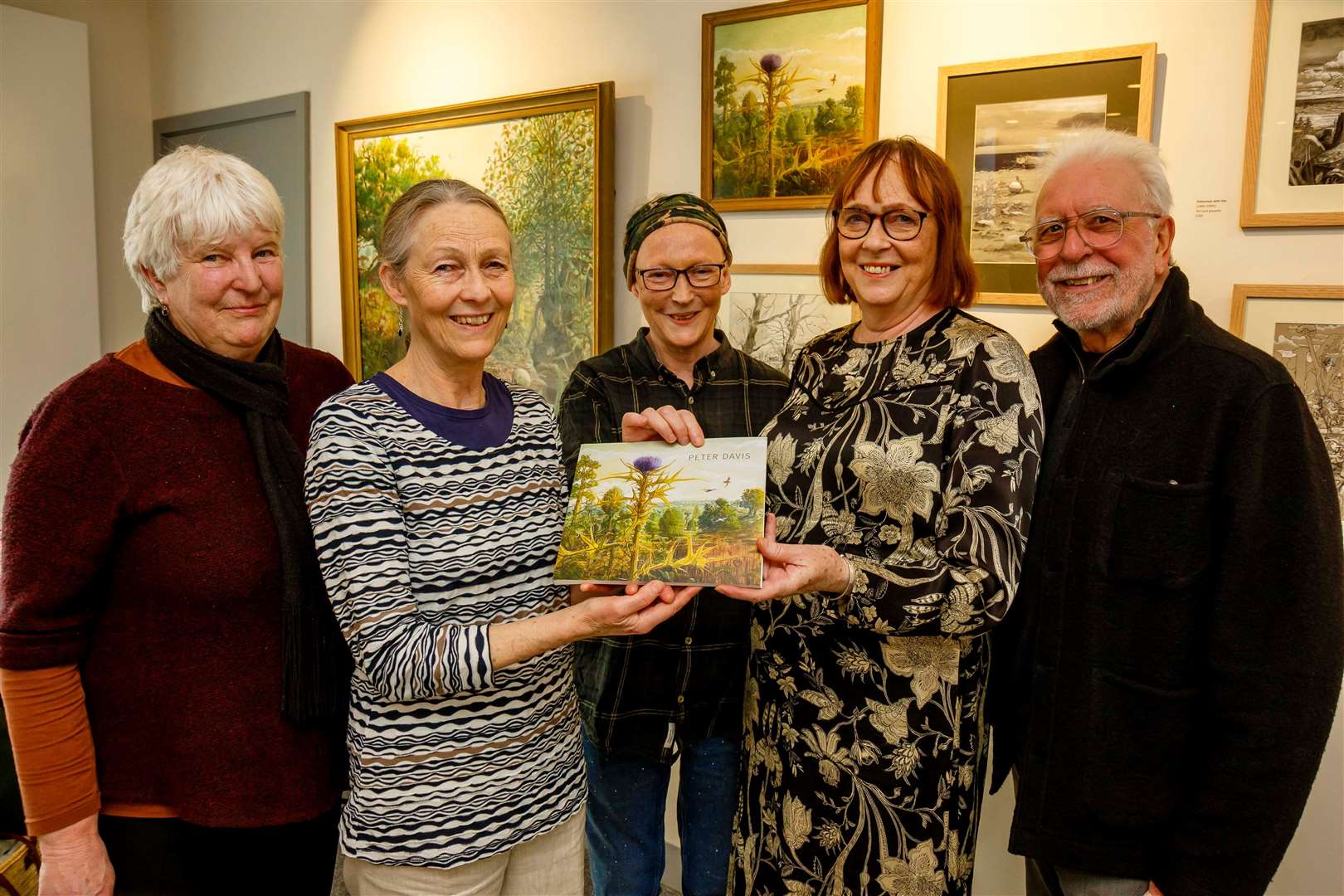 Bridget Heriz, Celine Davis, Catherine Davis, Clare Sallah and Selwyn Taylor with a book celebrating Peter Davis’ work. Pictures: Mark Bullimore