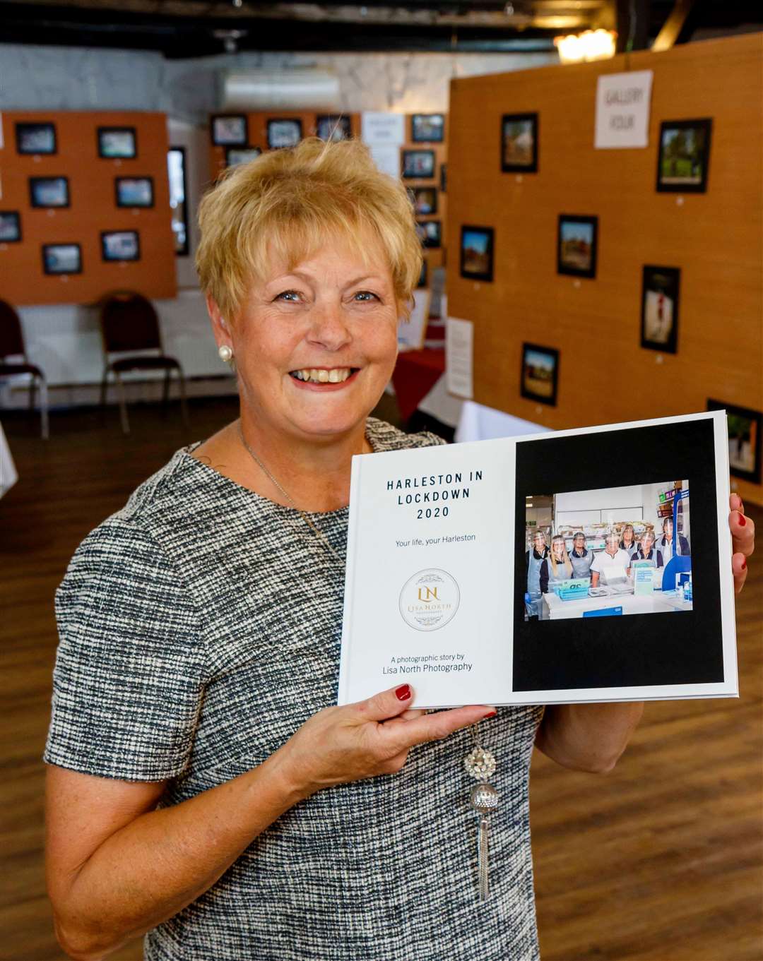 Lisa in the exhibition with her book of the pictures, with the profits from the sales going to East Anglian Air Ambulance. Picture: Mark Bullimore