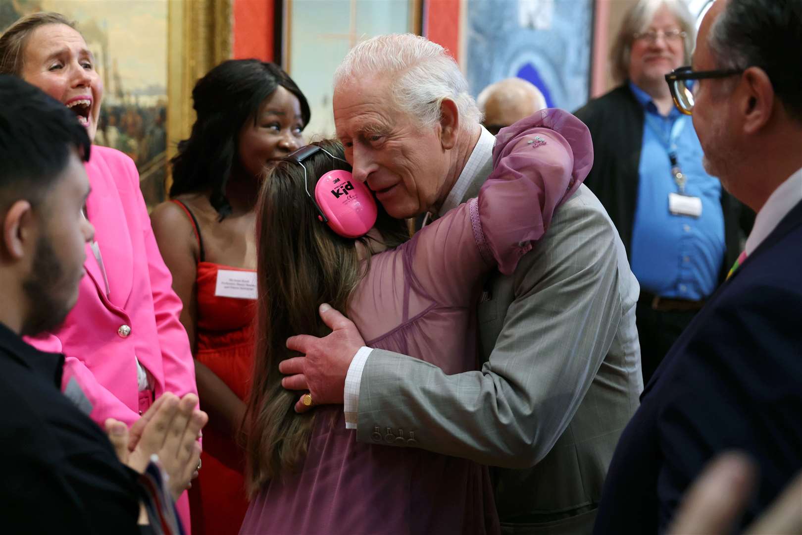 The King receives a hug from Florence McGrellis during a visit to Cartwright Hall in Bradford (Chris Jackson/PA)
