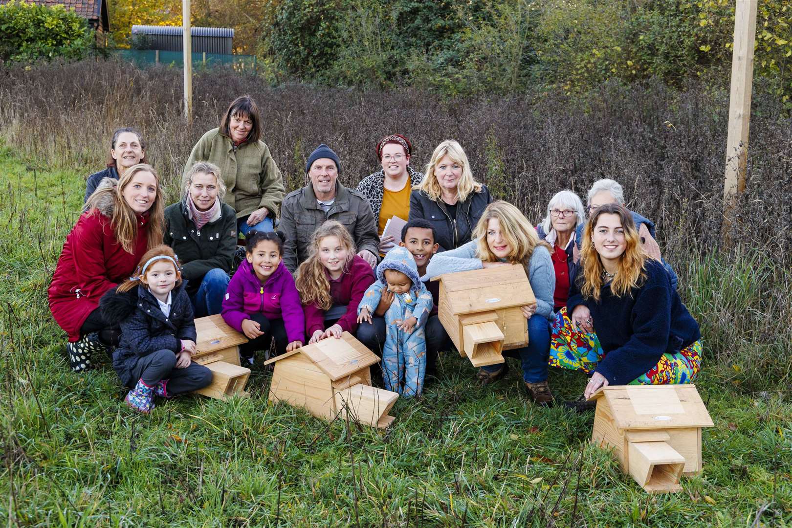 Members of the Fersfield Hedgehog club with some of the Hedgehog houses which have been placed in the community playing field. Picture: Mark Bullimore Photography 2022