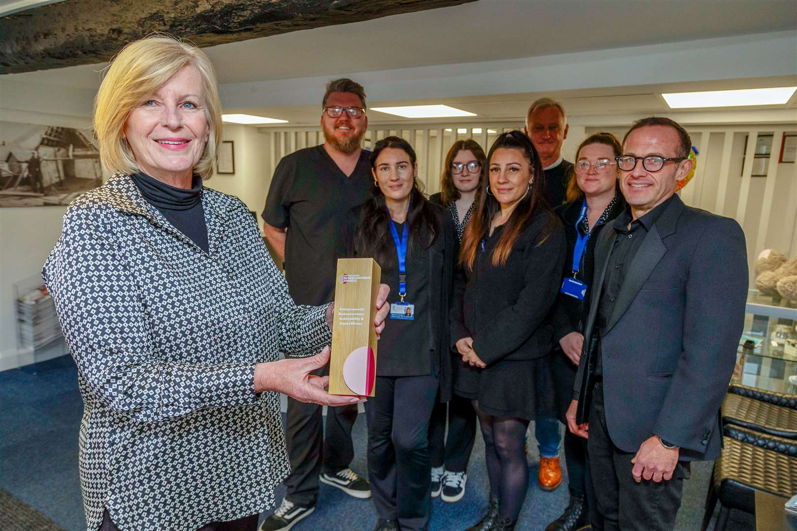 Tracy Turner, flanked by members of her team, shows off her award. Picture: Mark Bullimore
