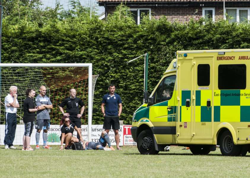 STOP IN PLAY: Ambulance crew tend to Norwich United's Ben Thompson, who suffered one of two serious injuries during Saturday's match, which was eventually abandoned