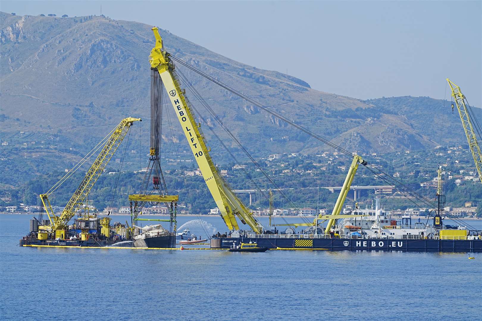 Water is pumped off Mike Lynch’s superyacht the Bayesian as it is lifted to the surface near Porticello, Sicily (Peter Byrne/PA)