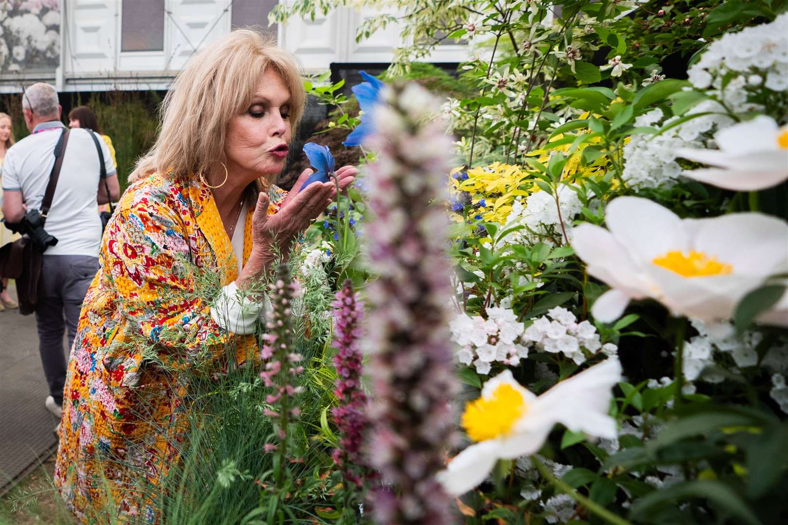 Dame Joanna Lumley sniffs a flower at the garden show (James Manning/PA)