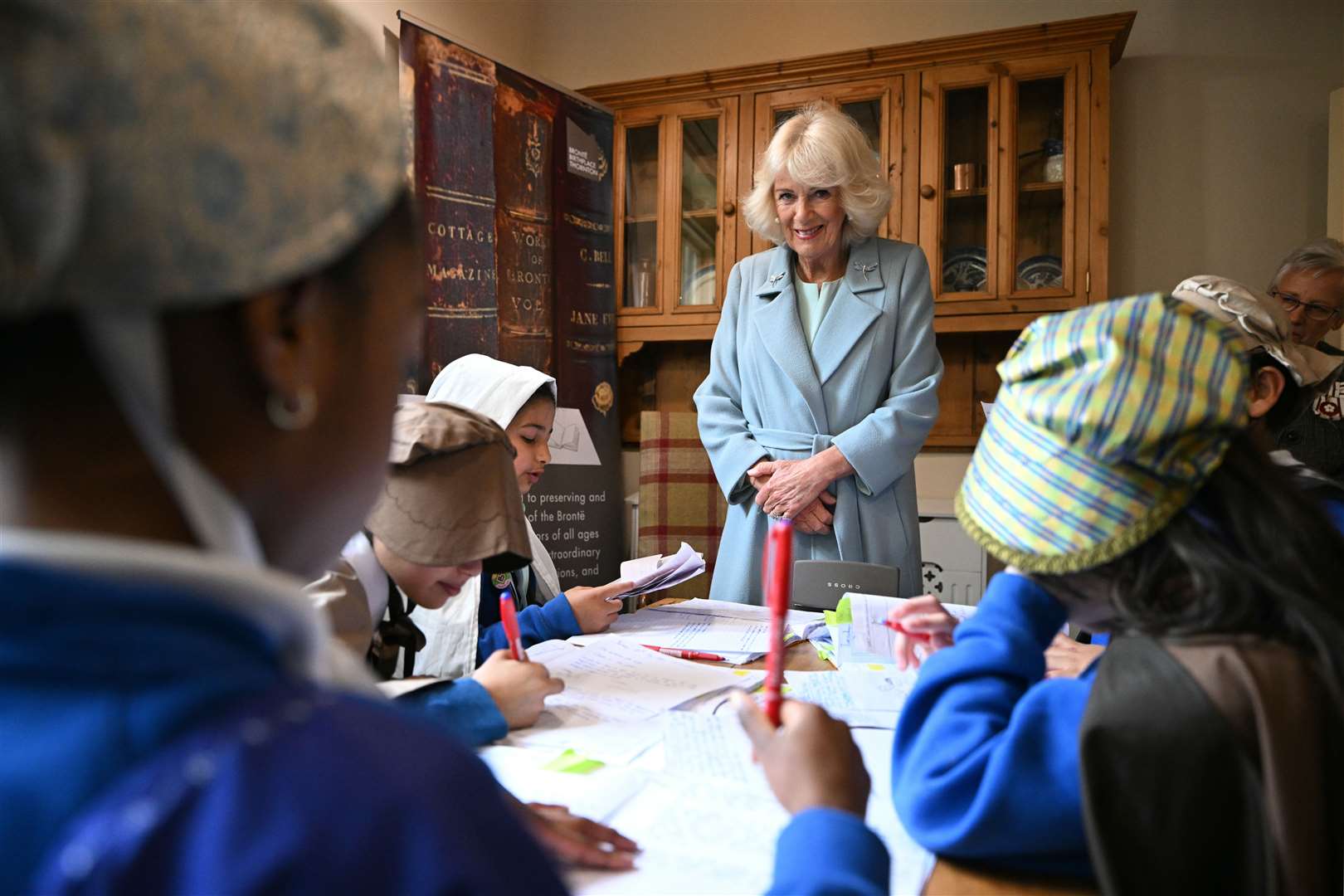 Camilla smiles as she meets children from the St Oswald’s Church of England Primary Academy (Oli Scarff/PA)