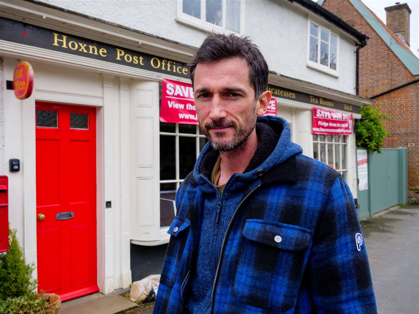 Mike Barton outside Hoxne Shop and Post Office. Picture: Mark Bullimore