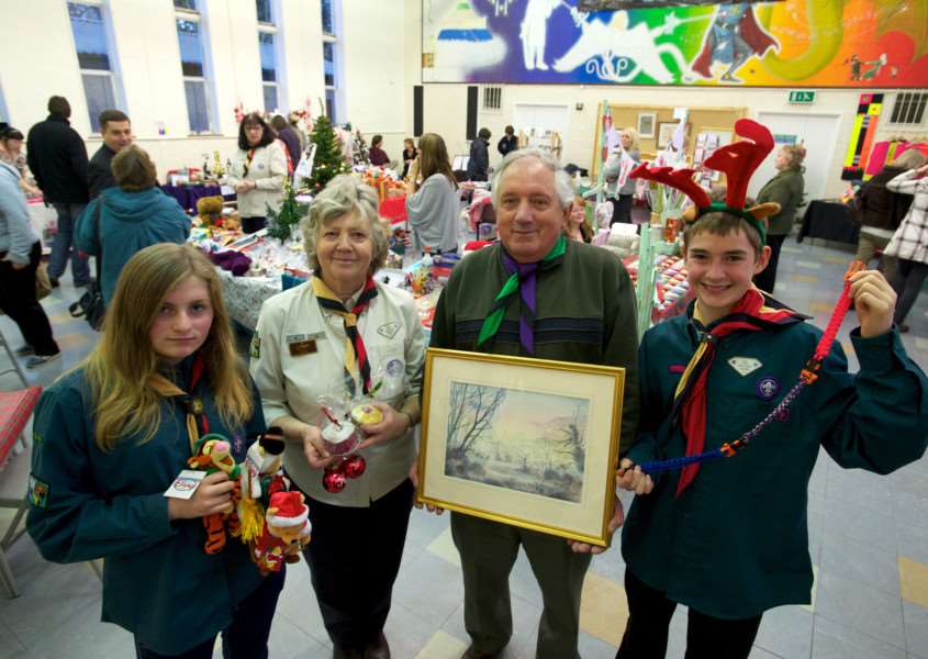 Diss, Norfolk. Diss 1st Scouts Festive Bazaar pictured from left `Kiera Renaut-Buttle, Sue Brazier, Arnie Johnson and Matthew Clark ENGANL00120120312103107