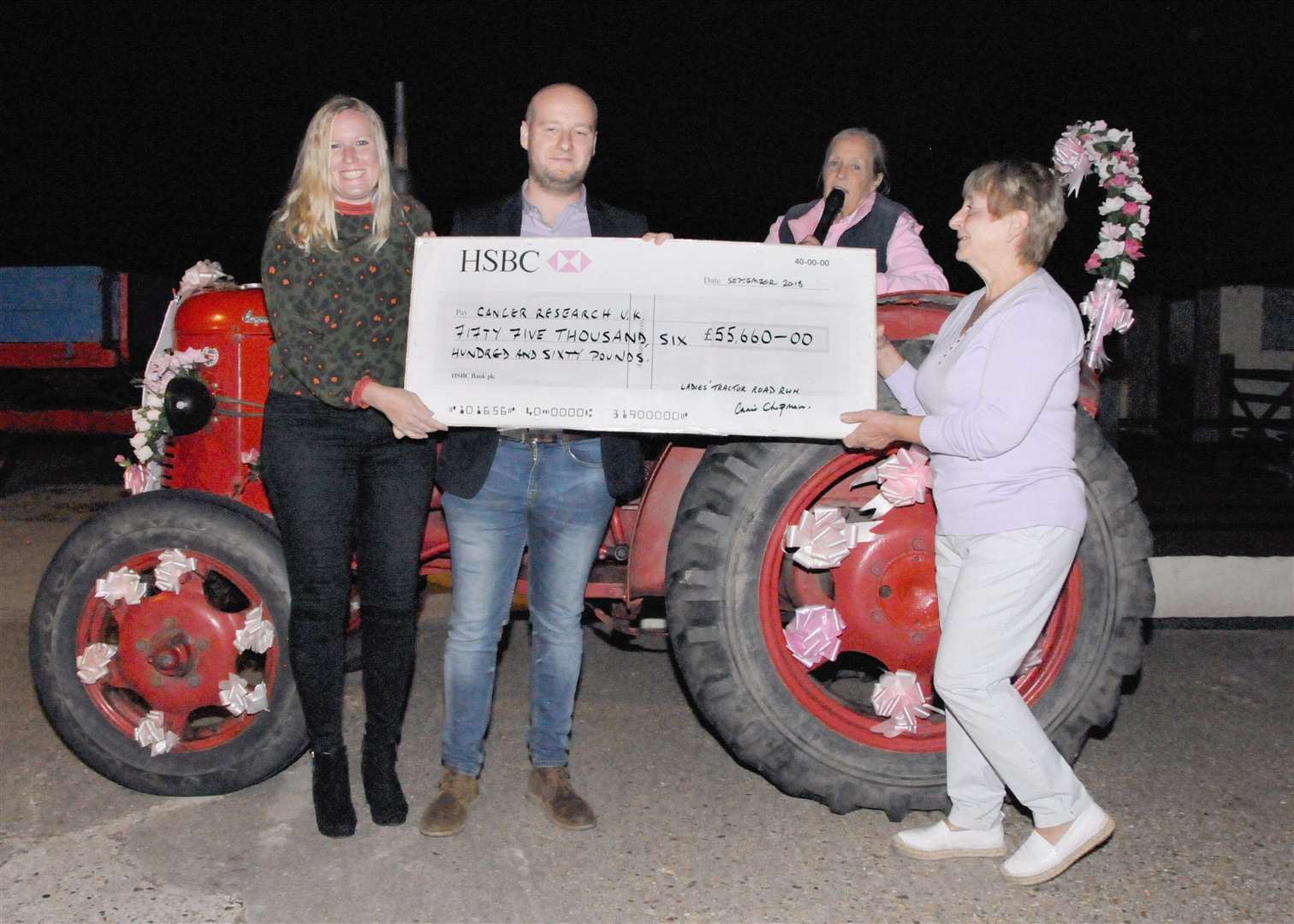 Nicholas Whymark, Alex Horne from Cancer Research UK with tractor run organiser, Annie Chapman, and Carol Wiles presenting the cheque.