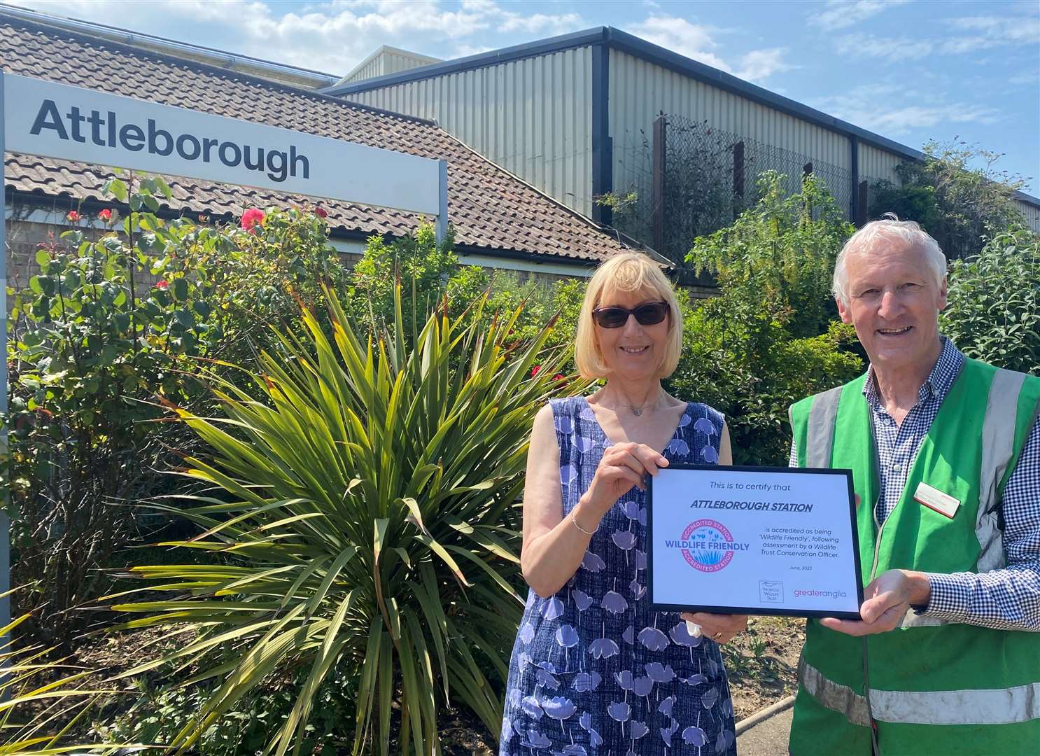 Two of Attleborough station's adopters, Jane Doughty and Cliff Amos with their Wildlife Friendly Station accreditation certificate. Picture: Greater Anglia