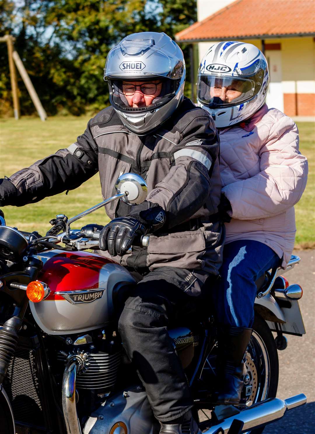 Phyllis Hunt riding pillion on the back of theTriumph motorbike. Picture: Mark Bullimore