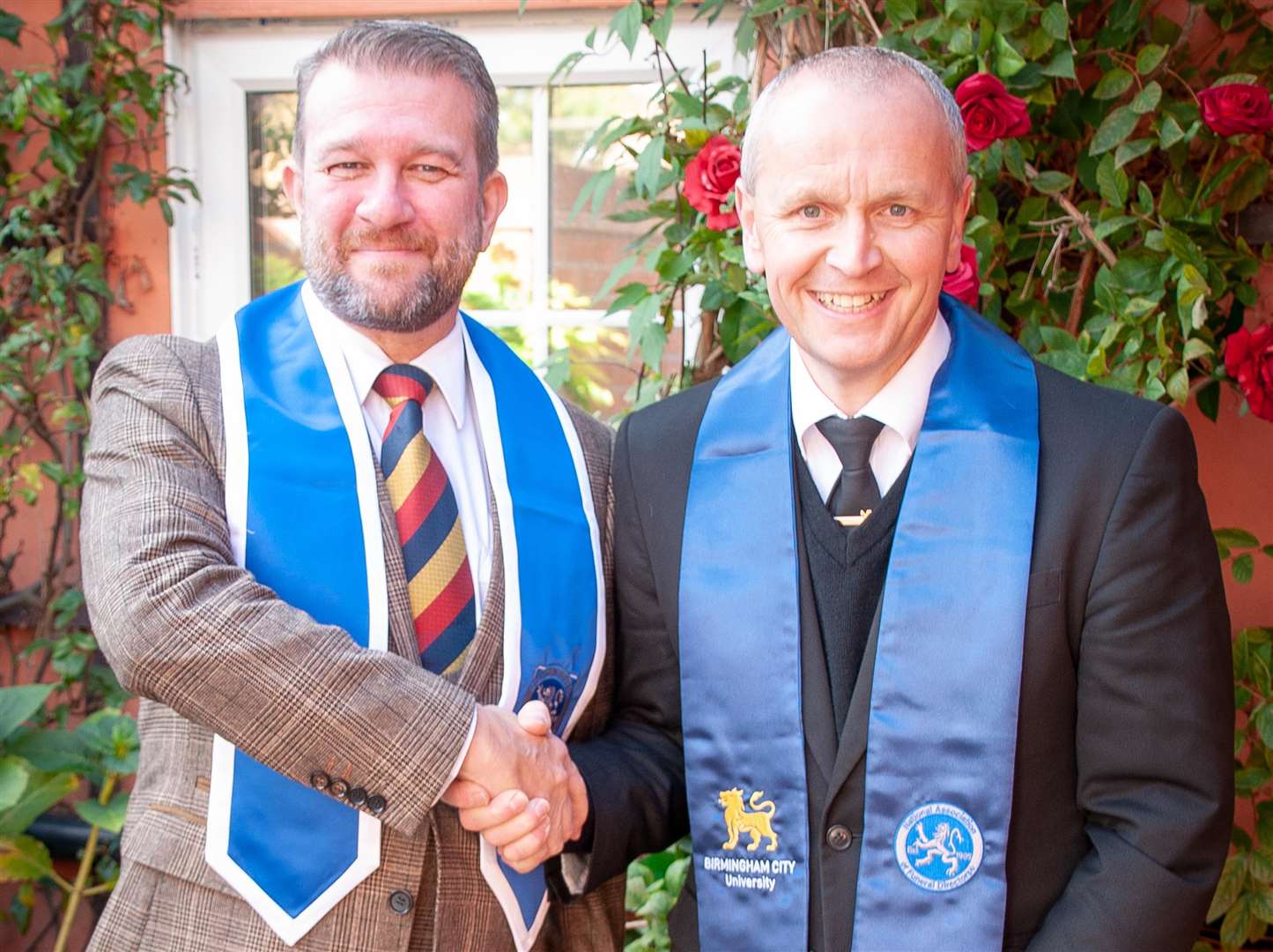THRILLED: Kevin Mobbs, right, receives his diploma in funeral arranging and administration.