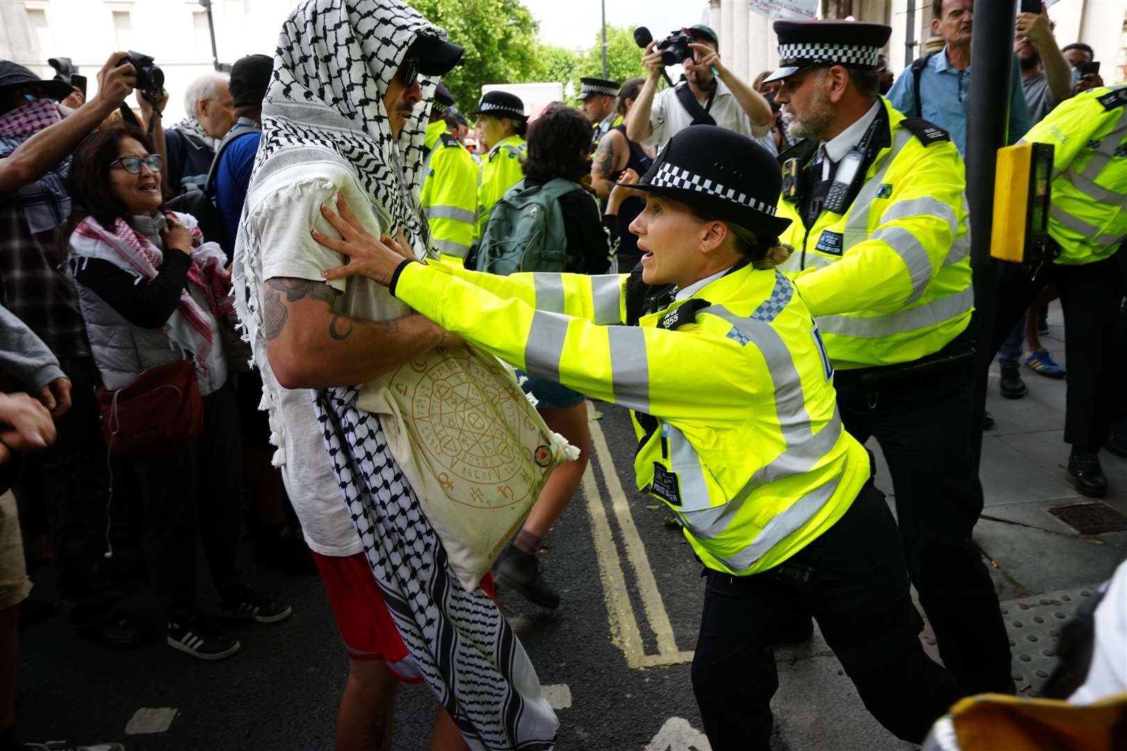 Police officers and protesters during the demonstration at Trafalgar Square (Jeff Moore/PA)