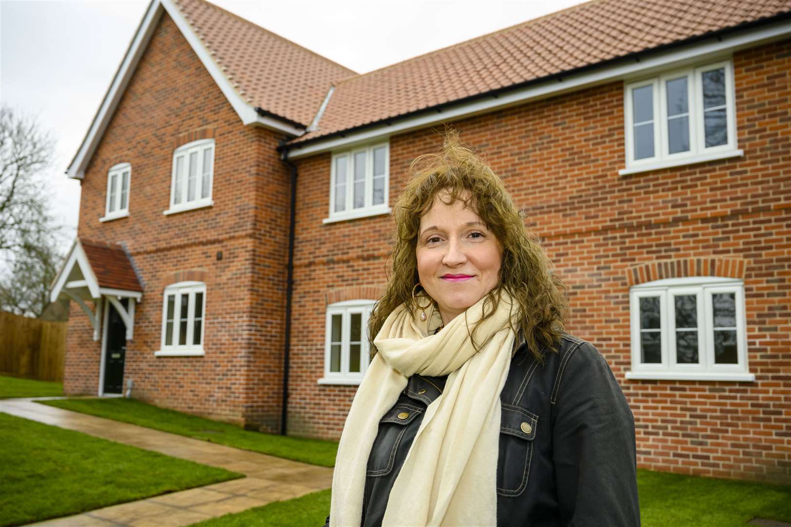 Mid Suffolk Cllr Lavinia Hadingham pictured in front of one of the homes in Abbotts Way. Picture: Mark Bullimore Photography 2022.