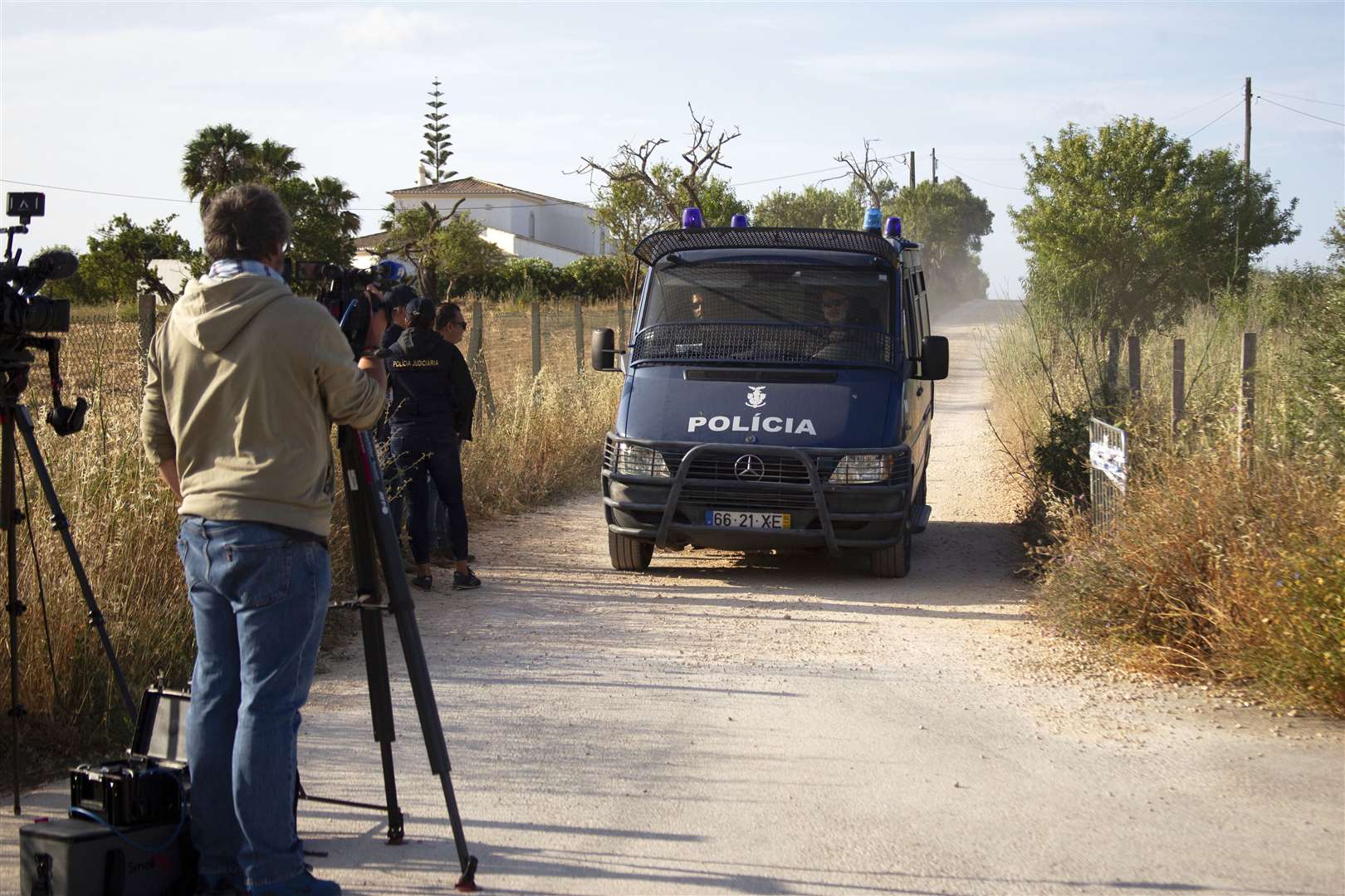 A Portuguese police van driving down a lane near where a search is taking place (Joao Matos/AP)