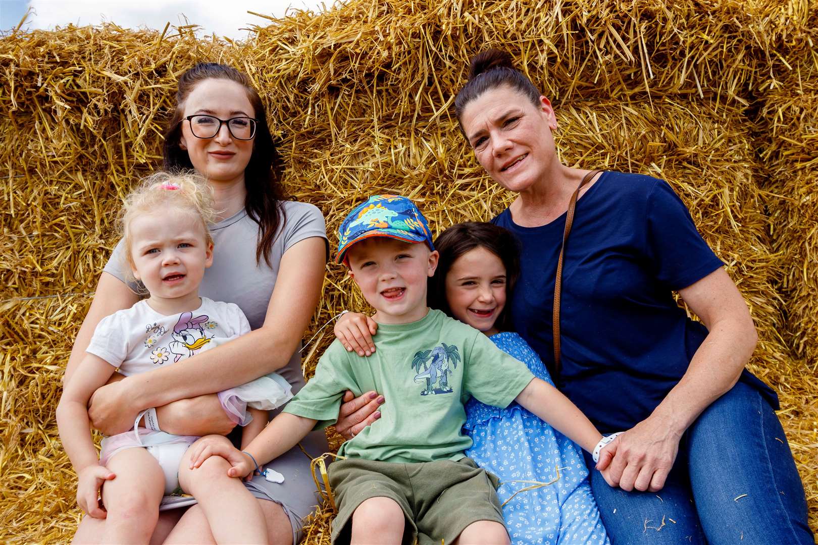 Millie Mark, Hayley Searle, Bodhi Mark, Hattie Wright and Sindy Wright take a break on some hay bales.