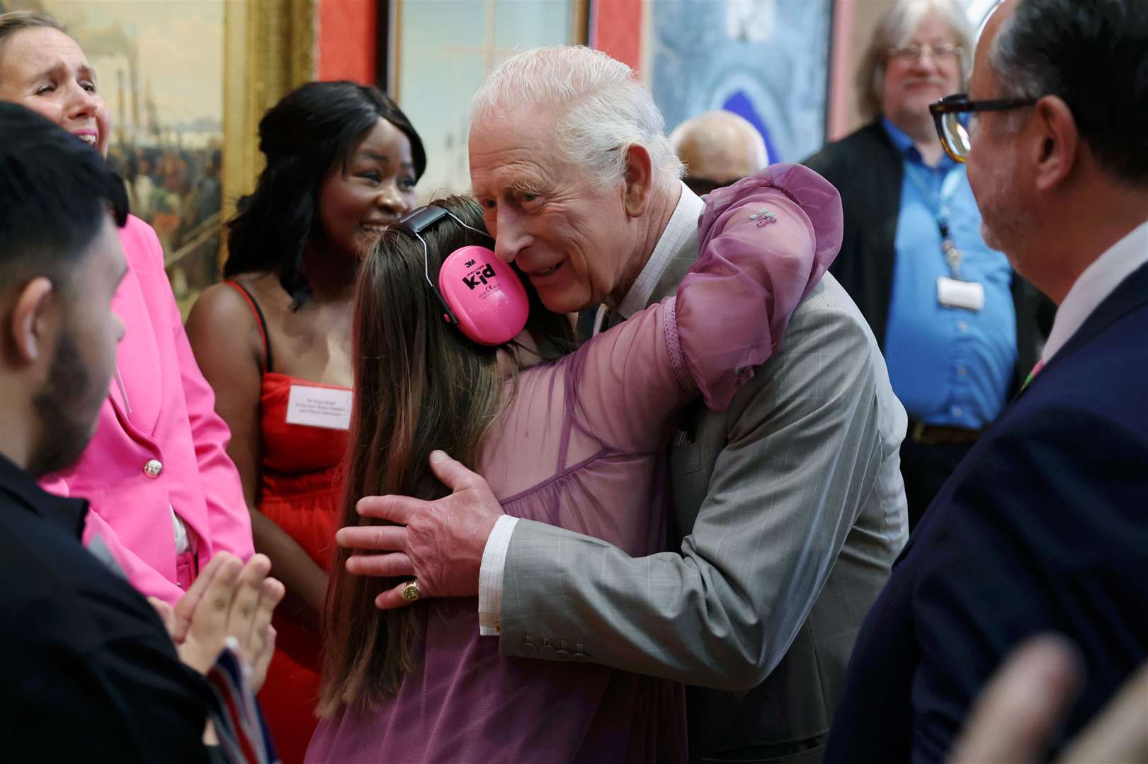 Charles is hugged by Florence McGrellis during a visit to Cartwright Hall (Chris Jackson/PA)