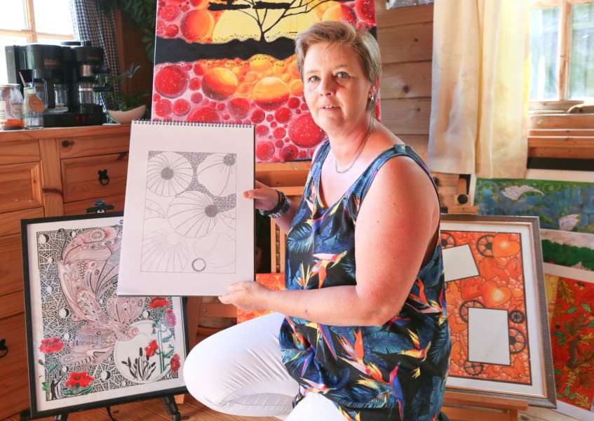 MDEP-05-07-2017-008 Artist Karen Harper with her Art. Her new book is called Spring Secret.