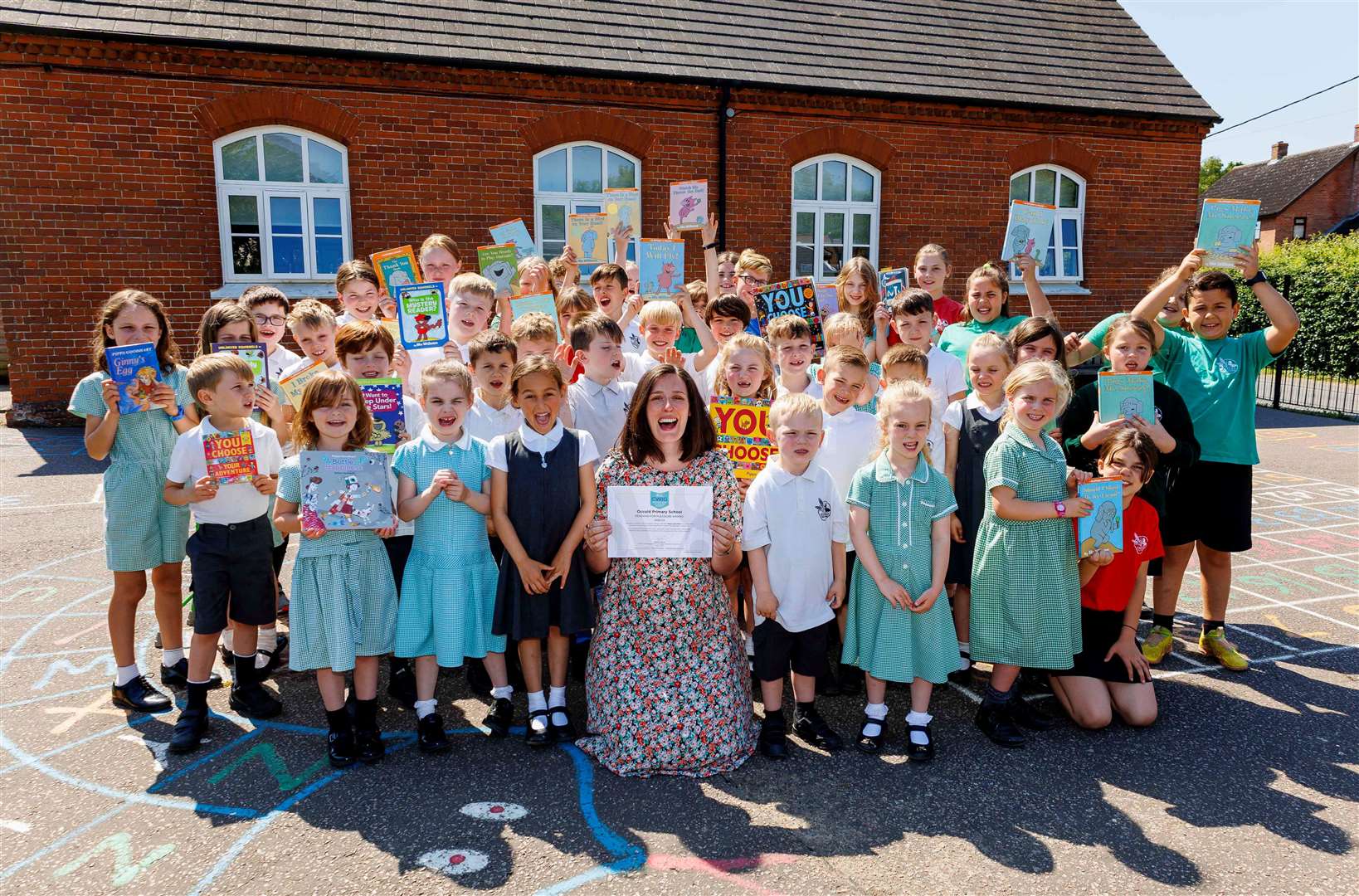Emily Rowe, head of school at Occold Primary, with all of the children at the school. Picture: Mark Bullimore