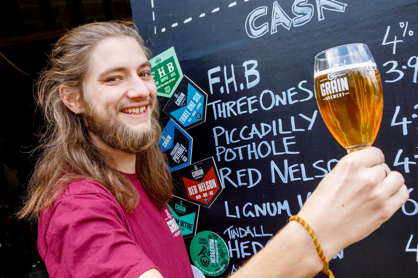 John Franks shows off one of the brewery’s beers.