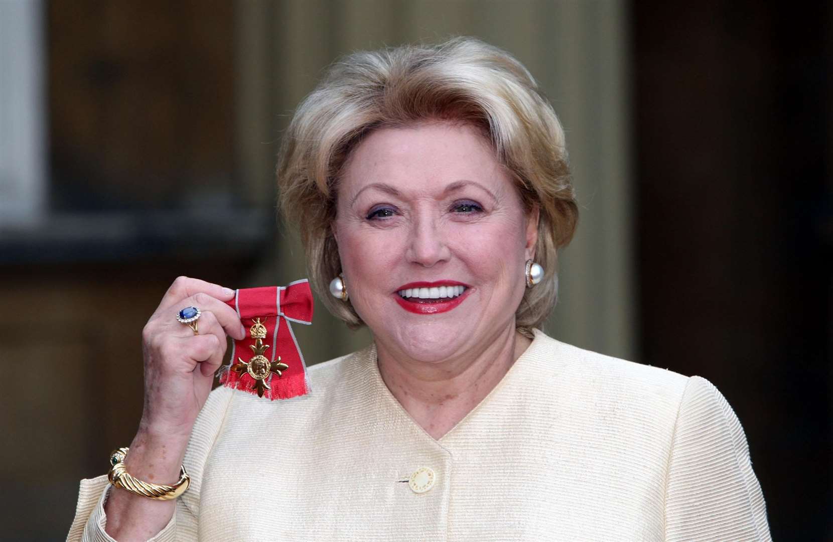 Author Barbara Taylor Bradford poses for pictures after she received her honour from Queen Elizabeth II (Steve Parsons/PA)