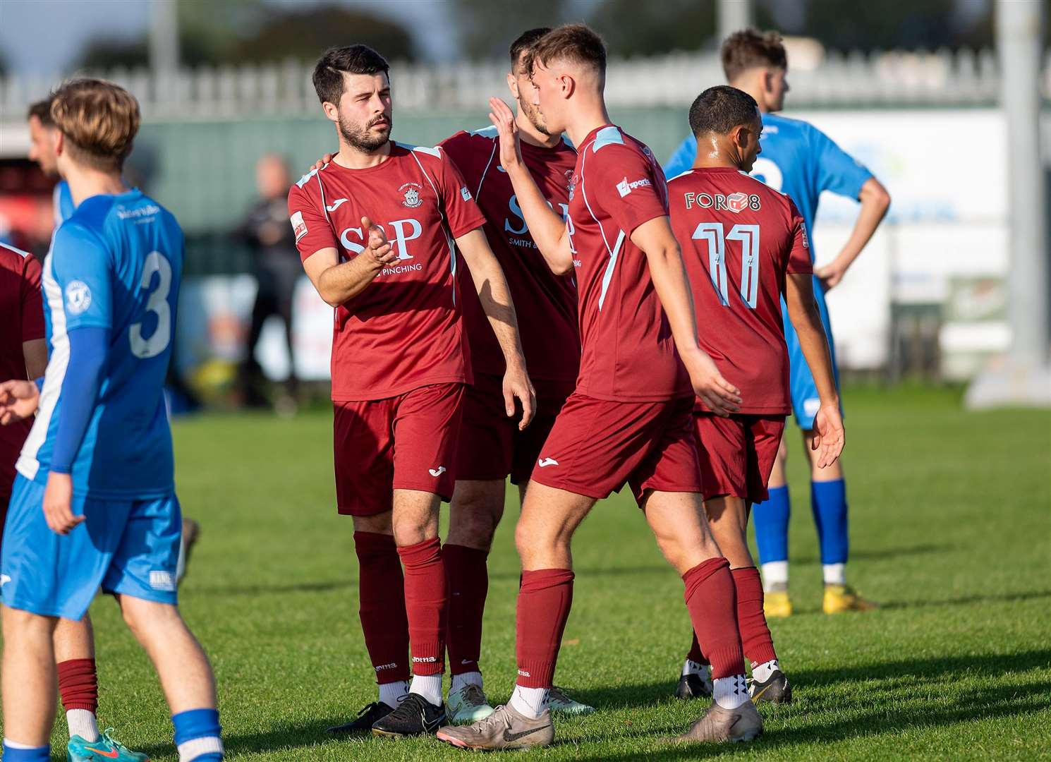 Dan Gilchrist (left, centre) celebrates his first-half goal for Thetford Town in their 6-1 home win against Cornard United in the FA Vase Picture: Mark Westley