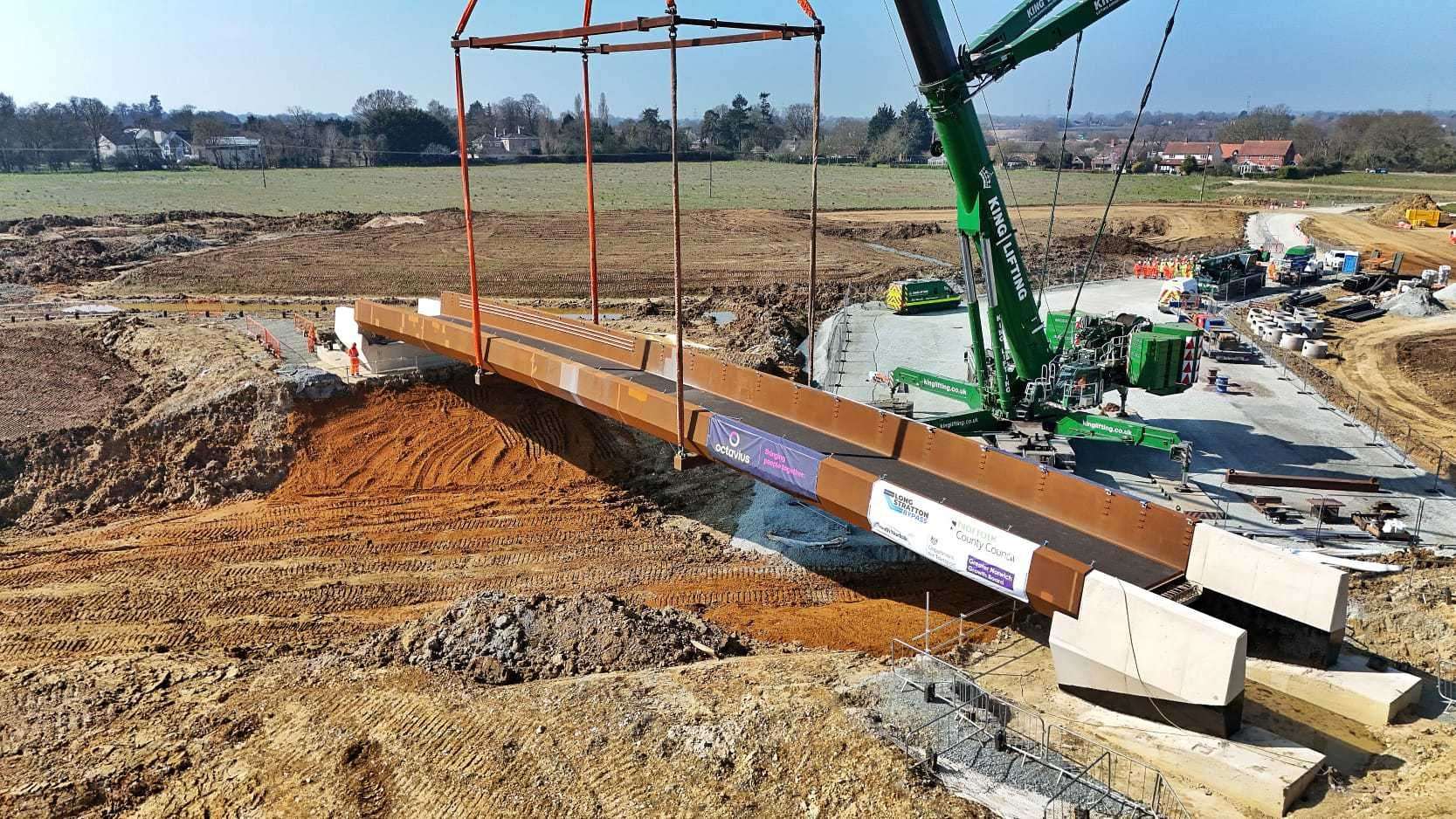 The footbridge is carefully lifted into position over the new road. Picture: Drone Vision Norfolk