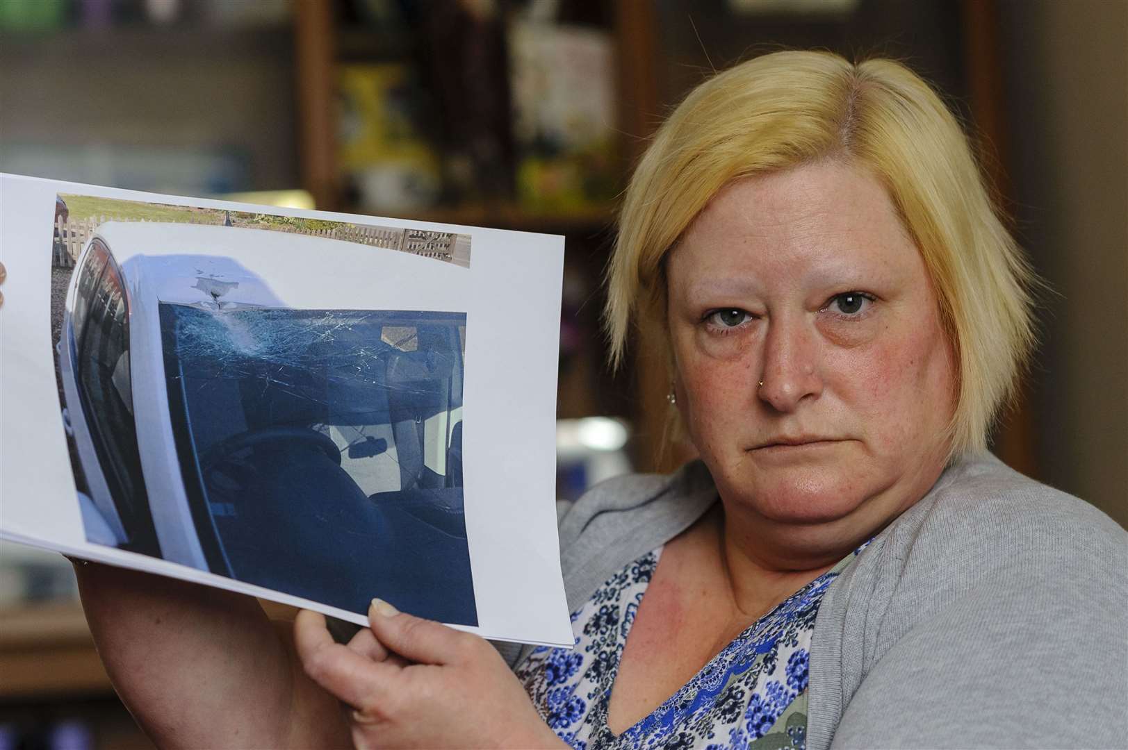 Gemma Wiles with a picture of her Skoda after the driver’s side was hit by what is believed to be a rock. Picture by Mark Bullimore.