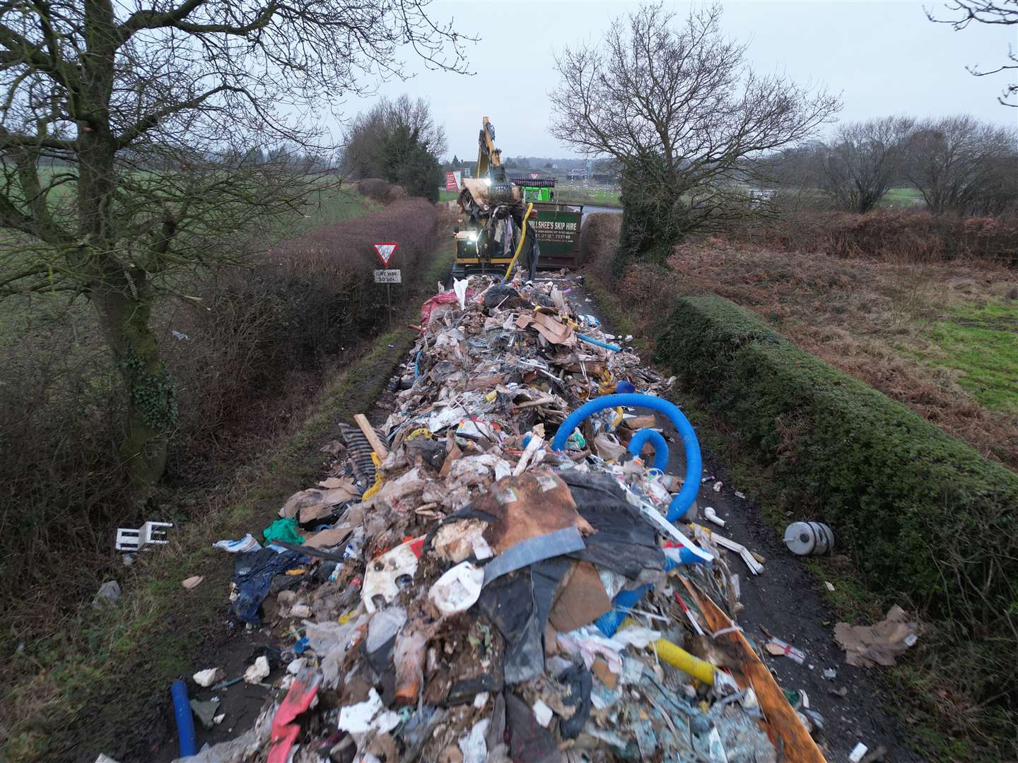 Contractors removing the 20-metre-long pile of waste (Phil Barnett/PA)