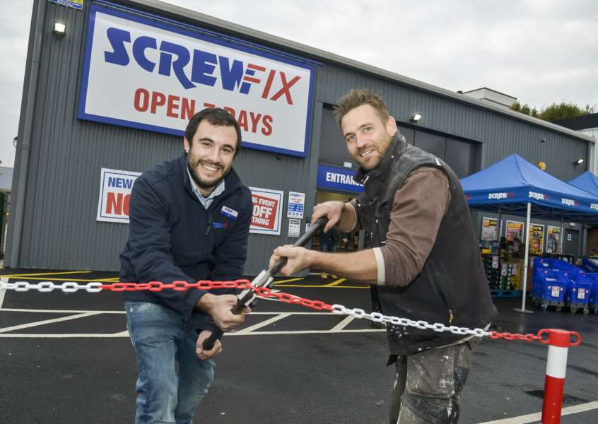Aristos Yianni, store manager, and local tradesman James Broyd mark the opening of the new Screwfix in Diss.