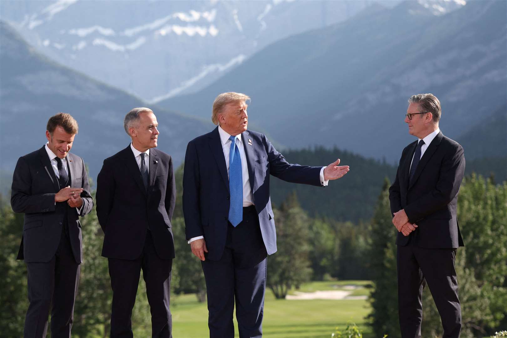 French President Emmanuel Macron, Canada’s Prime Minister Mark Carney, US President Donald Trump and Sir Keir Starmer attend a family photo session during the G7 summit (Suzanne Plunkett/PA)