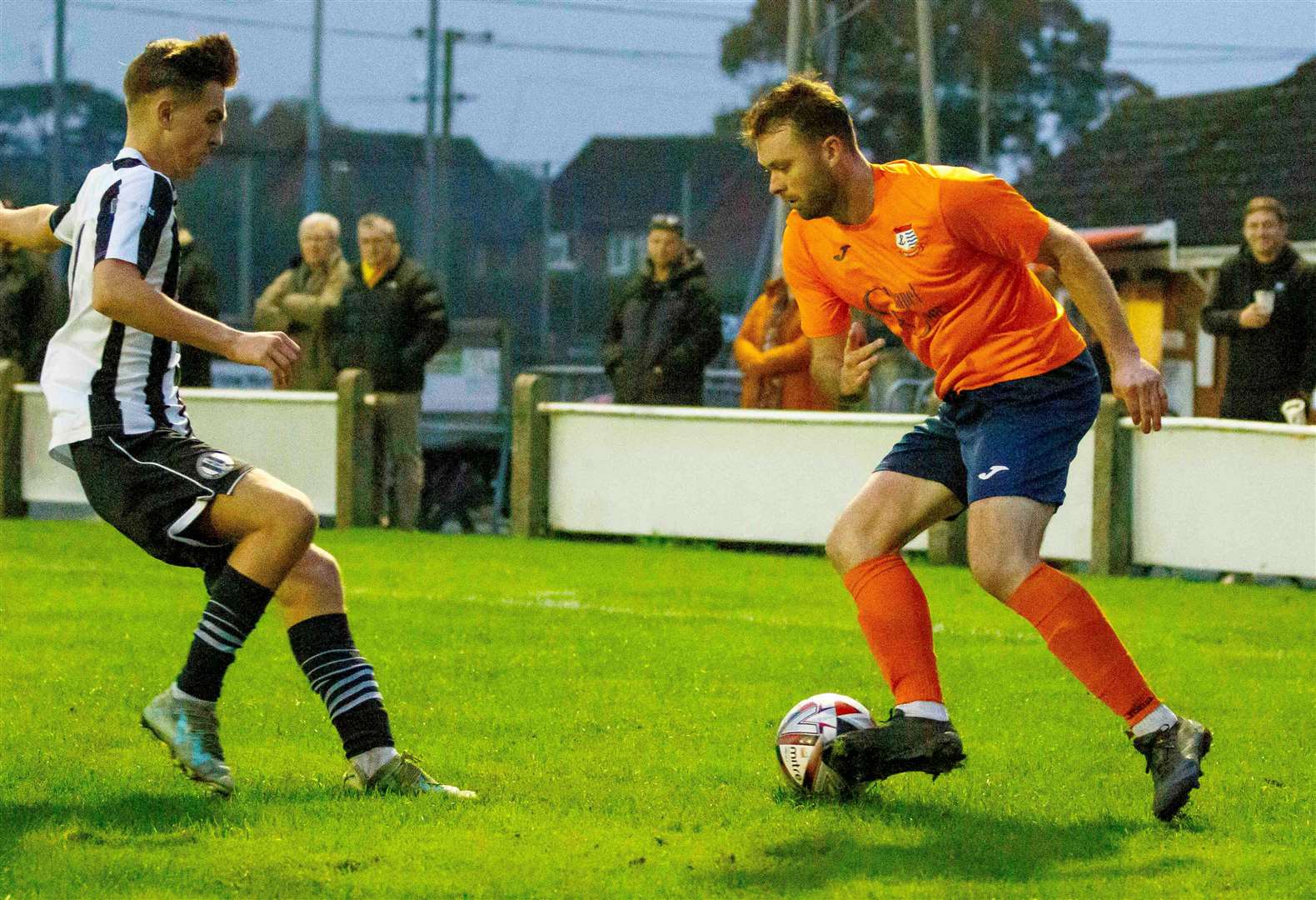 Diss Town’s Charlie Webb takes on Swaffham Town’s Blake Foster Picture: Mark Bullimore